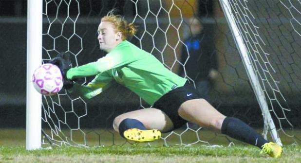 Fletcher High goalkeeper Taylor May dives to her right to stop a penalty kick during the early stages of Jan. 21’s regional quarterfinal playoff game against Nease at Jack Taylor Stadium. (photo by Rob DeAngelo)