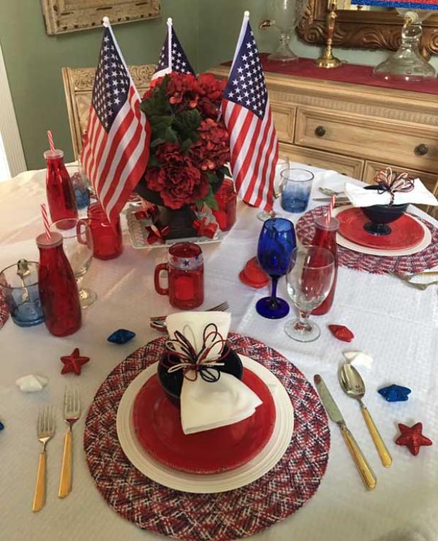 Inexpensive tablecloths, dishes, flags and flowers combine to create an impressive, budget-friendly table setting. (photo submitted)
