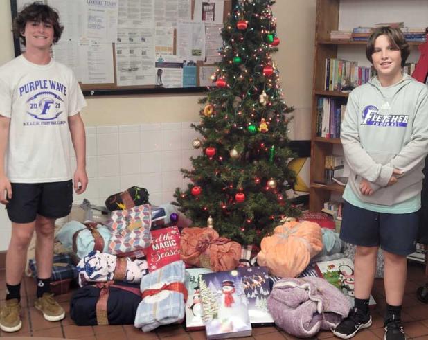 Nate and Brady Phillips are shown with the shoeboxes for delivery.