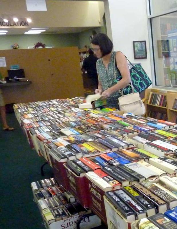 Rebecca Keene sorts through books at the Ponte Vedra Branch of the St. John's County Public Library. Work in the library will change the entrance temporarily and relocate the bookstore. (photo by Jessica Fondo)