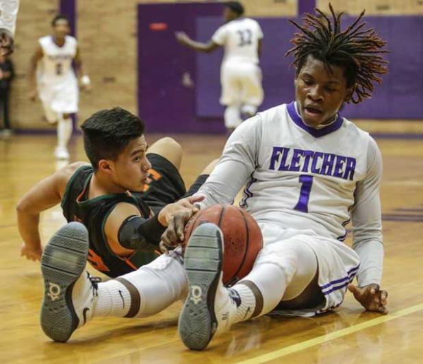 Fletcher boys basketball player Tyron Bond (1) fights for a loose ball with Mandarin’s Andrew Duomh (3) last Thursday. Bond scored 31 points in the game as Fletcher went on to win for the first time this season, an 85-58 route over the Mustangs. (photo by David Rosenblum)