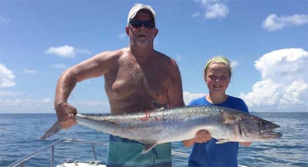 Emma Pugh shows off her 28.45-pound kingfish with the help of her dad. (photo submitted)