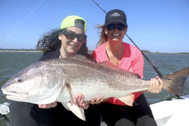 Kathleen Tobin and Ashley Cokley with one of several red drum caught last weekend near the Little Jetties Park. (photo submitted)
