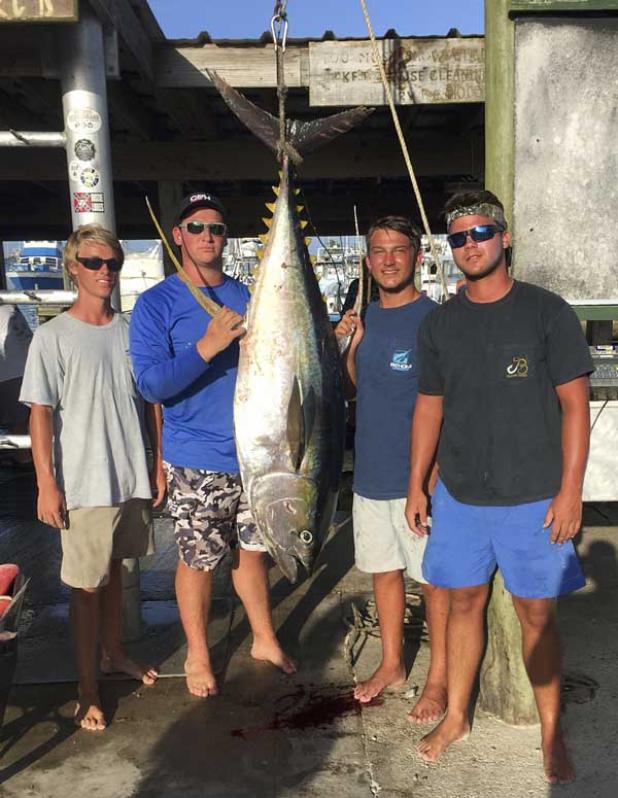 Jacksonville Beach locals Austin Harris and friends pose with a 139-pound yellow fin tuna caught on a trip to Louisiana. (photo submitted)