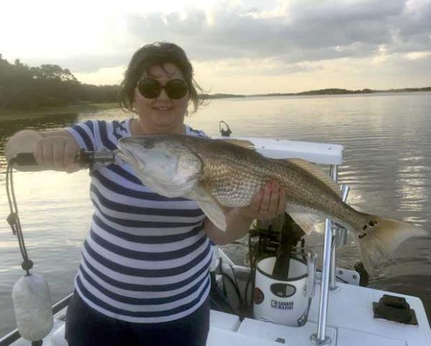 Tonya Dana holds a 30.5 inch redfish caught during the early evening bite in Palm Valley. (photo submitted)