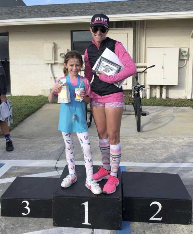 Age group winner Amanda Napolitano, right, stands on the winner's podium with her daughter, Anna, who won the one-mile race. (photo submitted)