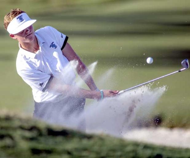 Ponte Vedra golfer Spencer Slayden hits from a greenside bunker on the 18th hole at Atlantic Beach Country Club during a four-team meet. (photo by David Rosenblum)