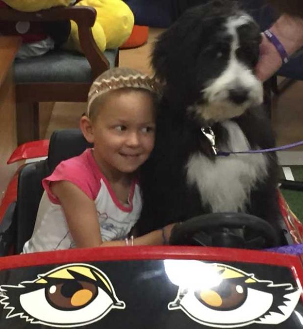 Rue Andeer of Ponte Vedra Beach is surprised to get a puppy from Dreams Come True. (photo submitted)