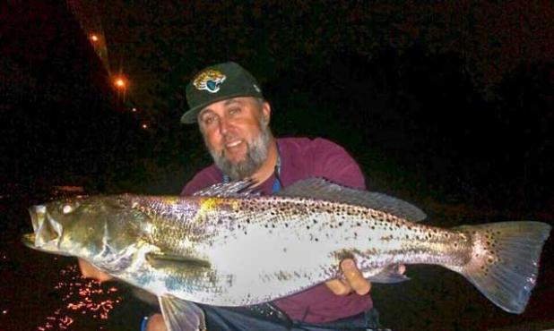 Eddie Cabler with a tank of a trout.