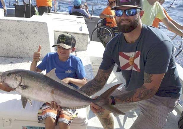 First mate Beau Hall with one of C. Mo’s Kids aboard the Mayport Princess. C. Mo’s Kids is a not-for-profit organization providing special needs children the opportunity to hunt, fish, camp and enjoy outdoor adventures. (photo submitted)