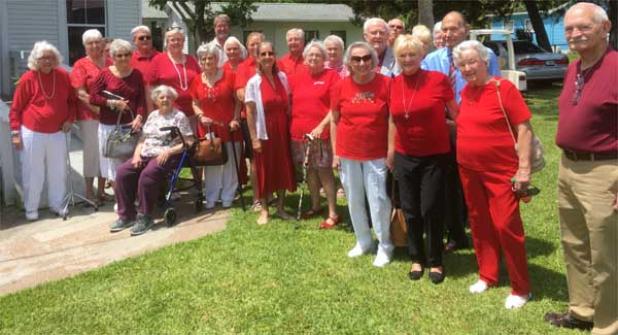 The congregation of Mayport Presbyterian Church wore red and gathered on the grounds to celebrate Pentecost, the birthday of the church universal. The Rev. Barbara Hamilton is in the center. (photo provided)