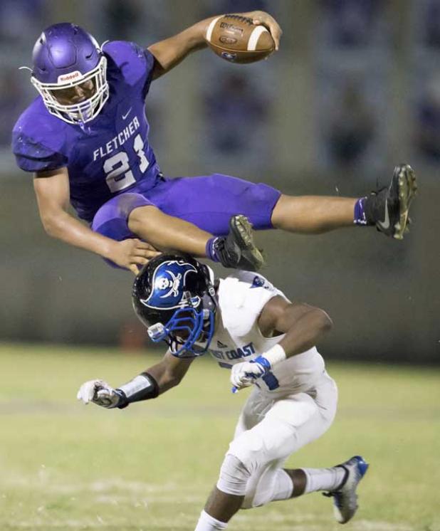 Fletcher linebacker Damien Anderson (21) leaps over First Coast wide receiver Marieo Thomas after intercepting a pass during the Senators 28-0 win over the Buccanners. (photo by Karl Schweinfurth)