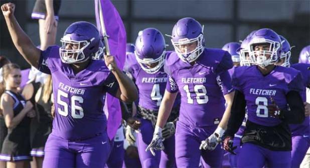 Fletcher offensive lineman Dametrius Harrison (56) leads the Senators football team out on the field during the home-opener. (photo by David Rosenblum)