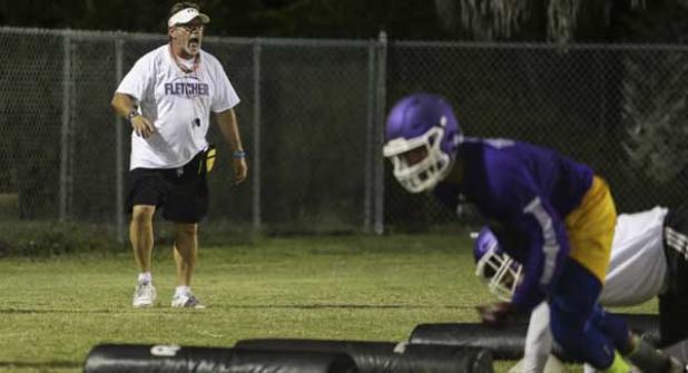 Fletcher’s first-year head coach Kevin Brown encourages players through a drill during the midnight practice session. (photo by David Rosenblum)
