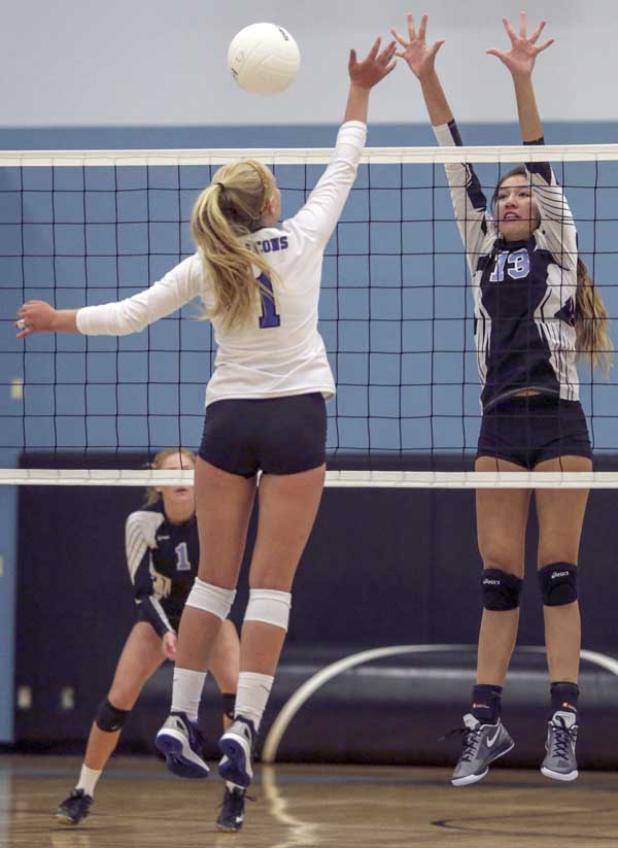 Sharks volleyball player Aya Kusumoto (13) attempts to block a shot by Pedro Menendez player Marley Banton (1). The Sharks won the match 3-0. (photo by David Rosenblum)