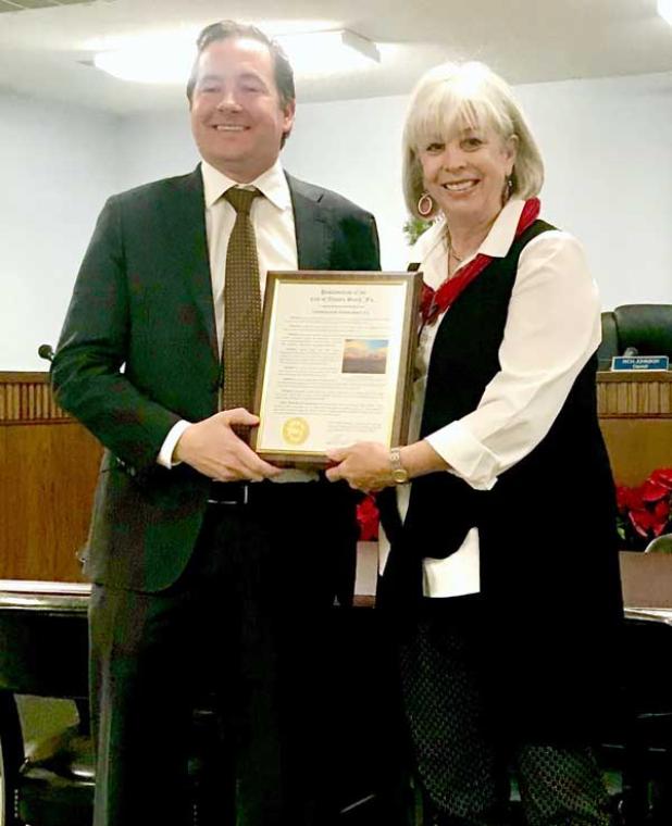 Atlantic Beach Mayor Ellen Glasser presents Atlantic Beach, N.C., Mayor Trace Cooper with a proclamation naming the two Atlantic Beaches sister cities.