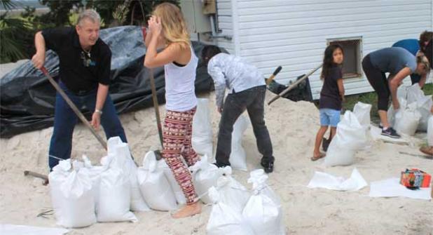 Volunteers fill sand bags at the Neptune Beach City Yard Tuesday afternoon to help residents brace for the arrival of Hurricane Matthew. (photo by David Bailey)
