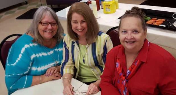 Candy Breidert, president, St. Vincent DePaul; MJ Brown, president of Beaches Community Kitchen; and Ellen Hopkins gather at the Pablo Towers Cafe.
