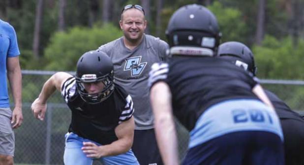 Ponte Vedra Sharks head coach Matt Toblin watches as members of the Sharks football team run through drills during practice. (photo by David Rosenblum)