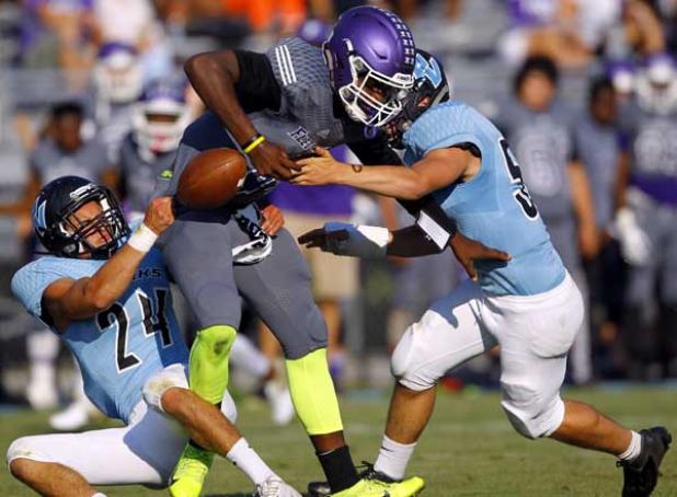 Fletcher High quarterback Tyron Bond is sacked and stripped of the ball by Ponte Vedra High linebacker Cade Macri (24) and defensive lineman Peter Merlini during the teams’ spring football game May 23 at Ponte Vedra High With varsity starters playing the first half, the host Sharks outscored the Senators 28-7. (photo by Rob DeAngelo)