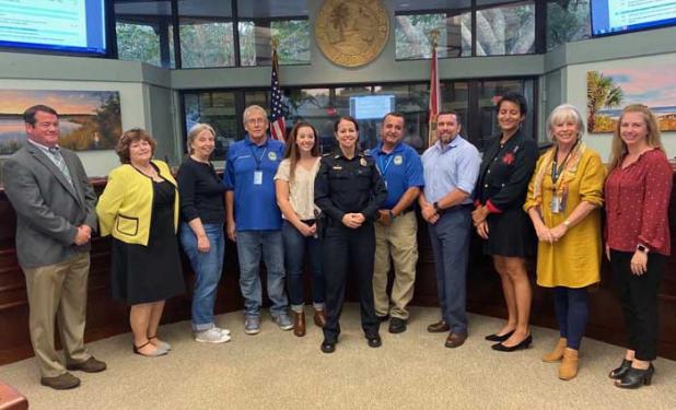 Shown are, from left, City Manager Shane Corbin; Commissioners Candace Kelly and Cindy Anderson; Joseph Schwarz; Aston Perry; Police Chief Michelle Cook; Ziad “Zee” Dagher; Lt. David Cameron; Commissioner Brittany Norris; Mayor Ellen Glasser; and Commissioner Blythe Waters. (photo submitted)