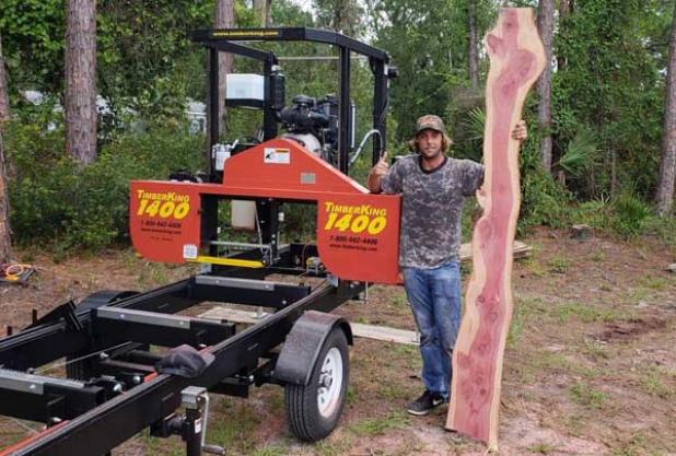 Matt Crego with wood he will carve into furniture.
