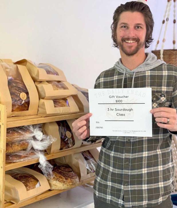 Trey Thompson shows a gift voucher for his sourdough-making class.