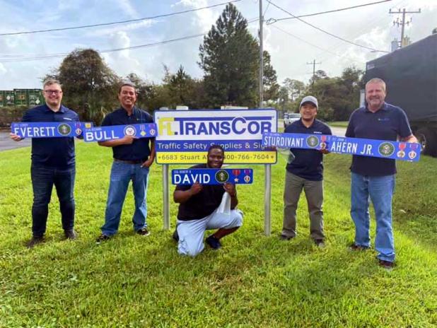 Kyle Dzina, John Graham, Trevor Willaims, Hieu Luu, and Peter Herbert pose with street signs honoring veterans that will be placed throughout Atlantic Beach. (photo submitted)