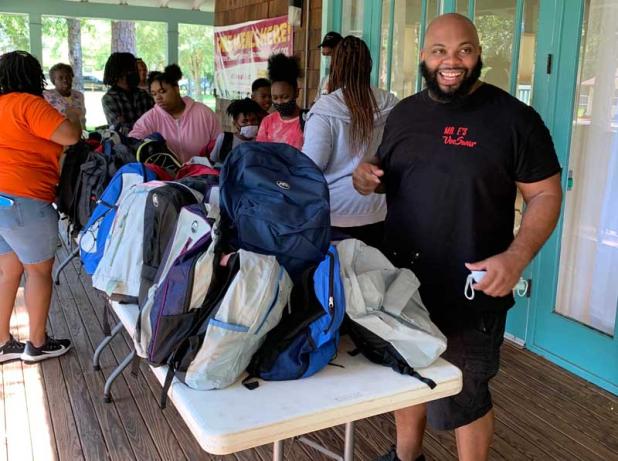 Lewis Washington, owner and operator of VooSwar, and a team of volunteers hand out backpacks at Gail Baker Community Center in Atlantic Beach. (photo submitted)