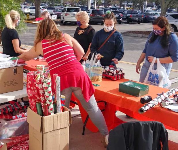 Patrons line up to have their gifts wrapped by volunteers from the North Florida Chapter of Multiple Sclerosis and Big Banana bicycle team. This service is donation-based, and all funds collected go toward supporting programs and services for those impacted by MS throughout North Florida. (photo submitted)